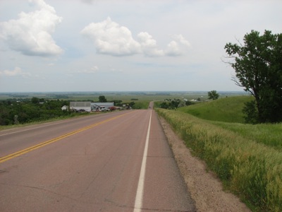 The rolling hills stop and the country becomes as flat as can be... in Wessington Springs, SD, heading east.